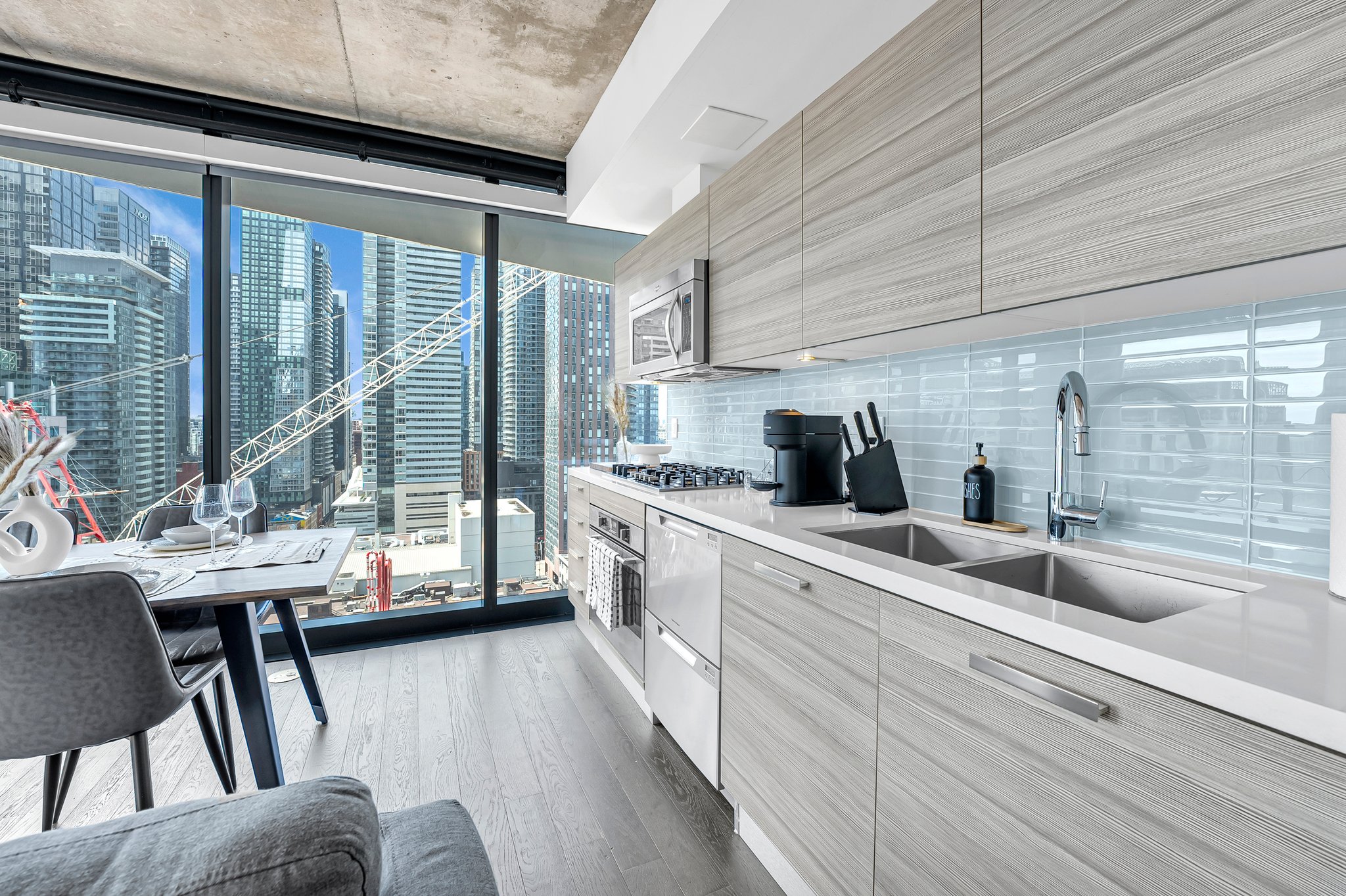 Galley kitchen with skyline views at 224 King St W, a Certus-managed Entertainment District rental