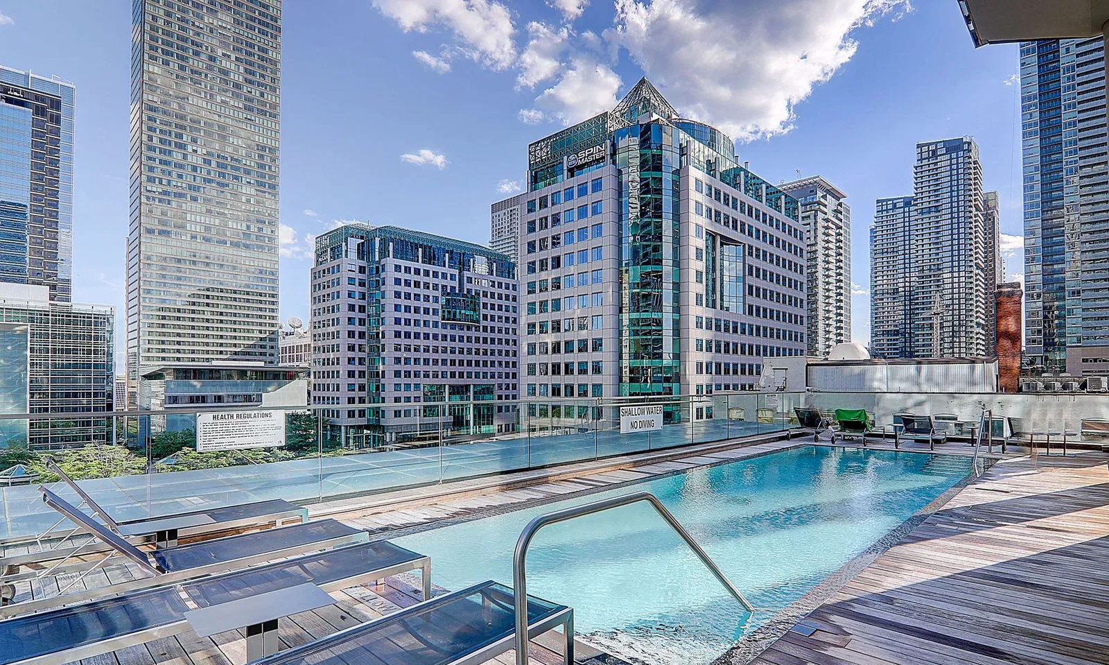 Rooftop pool at Theatre Park, 224 King St W, surrounded by the downtown Toronto skyline
