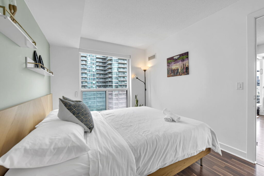 Calm staged bedroom with king bed in a Certus-managed Liberty Village rental at 80 Western Battery Rd