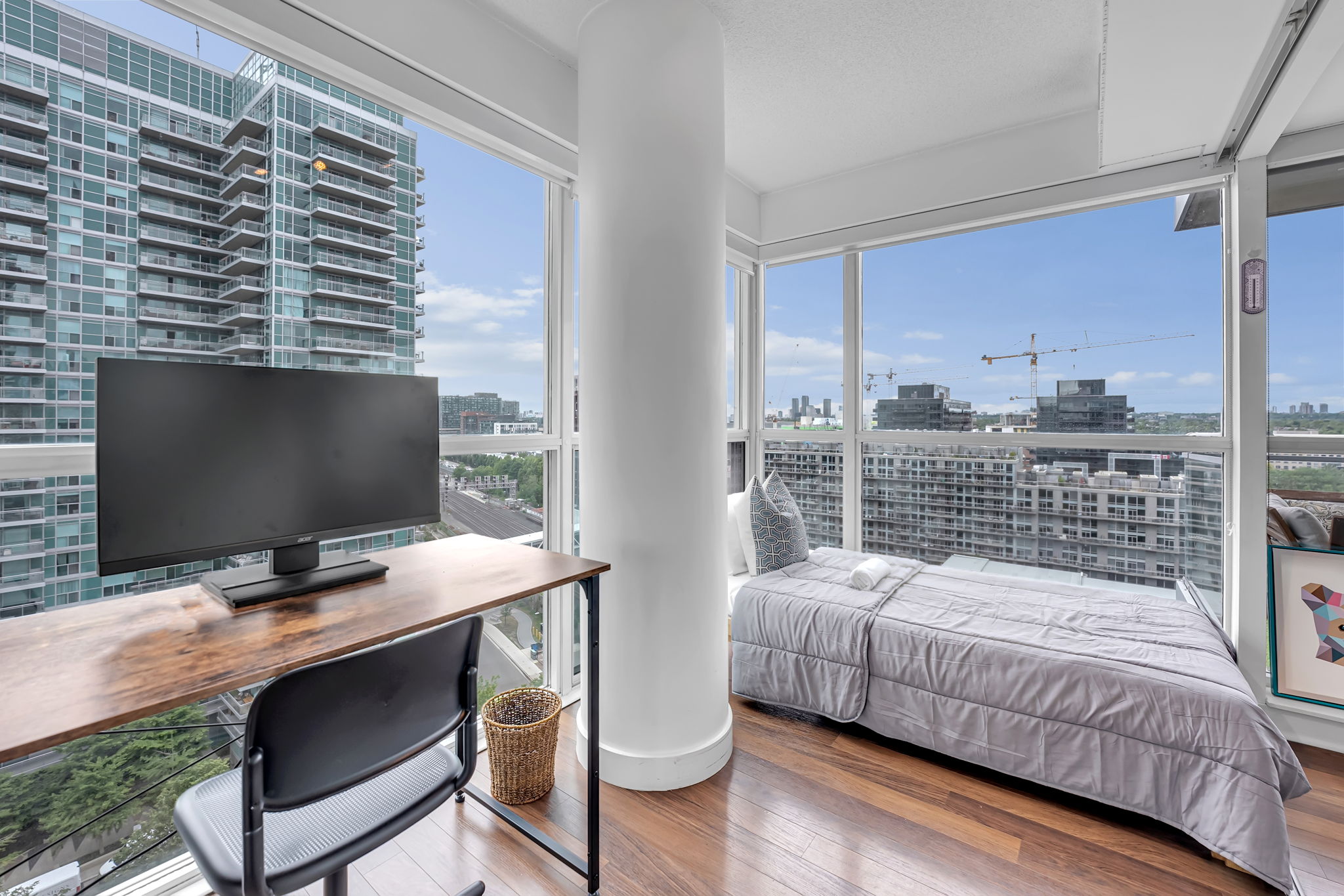 Bedroom with a dedicated work desk and corner windows over Liberty Village at 80 Western Battery Rd