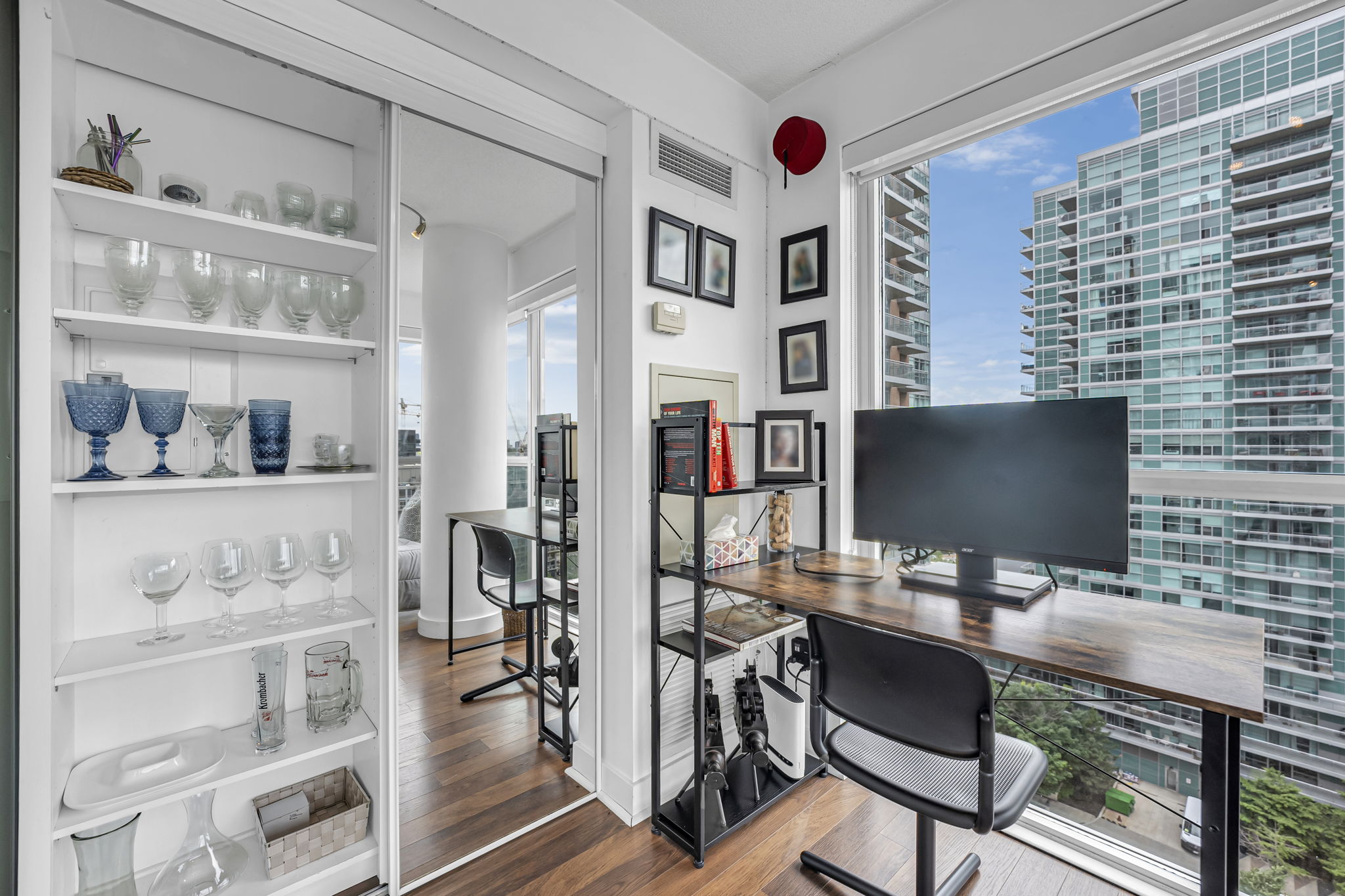 Compact den office with desk and open shelving in a Certus-managed rental at 80 Western Battery Rd, Liberty Village