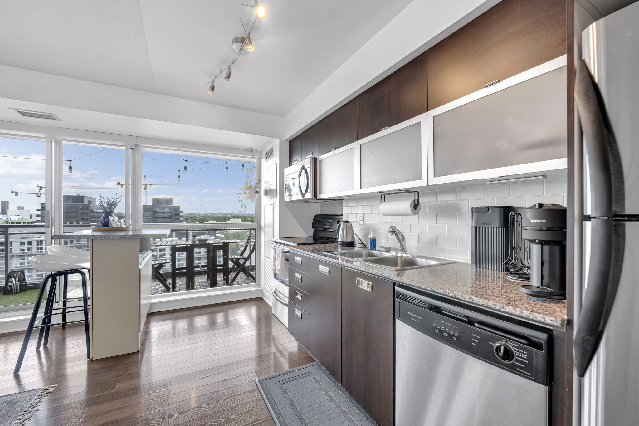 Kitchen with granite counters, stainless appliances and breakfast bar in a Certus-managed rental at 80 Western Battery Rd