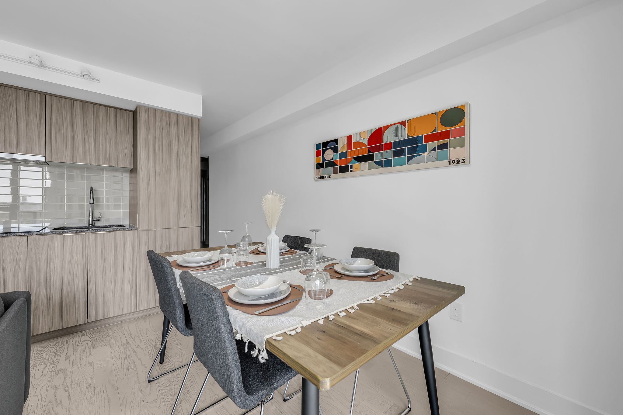 Dining table and kitchen in a furnished Certus-managed rental at 955 Bay St, Bay Street Corridor